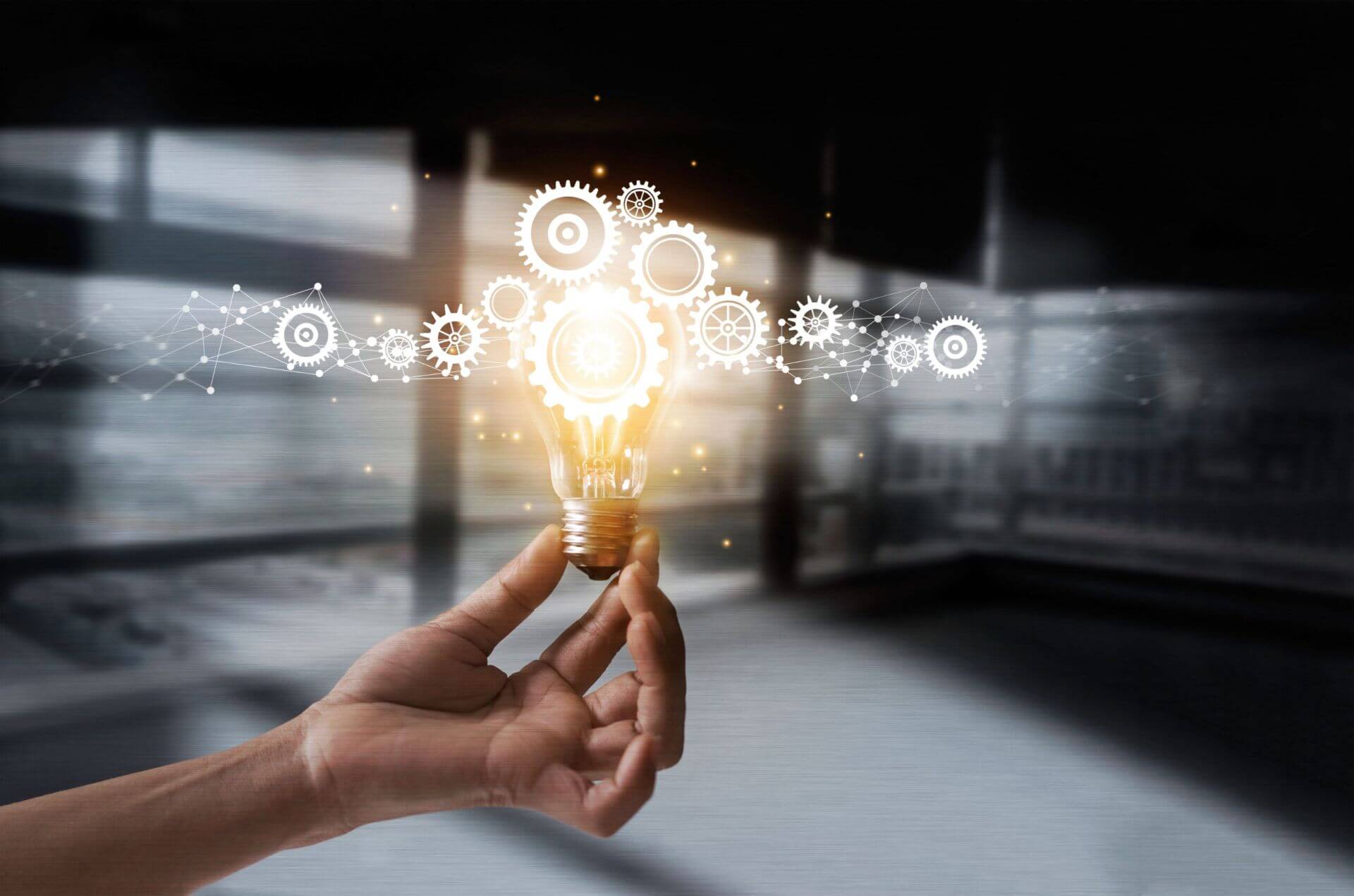 A Hand Holding a Light Bulb, Serve as Key Ideas for Business Growth
