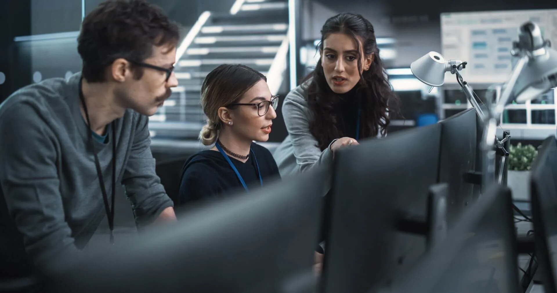 Three People in an Office Setting, Working Together to Provide IT Service